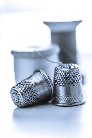 Thread bobbins and metal sewing thimblesの写真素材