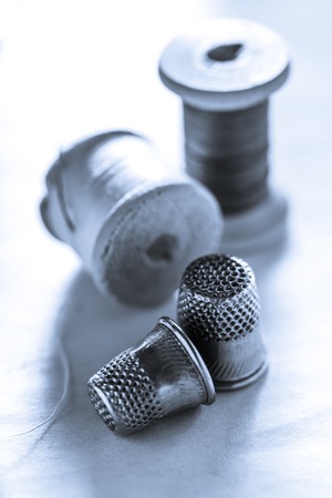 Thread bobbins and metal sewing thimblesの写真素材