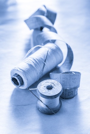 Sewing items and meter on paper