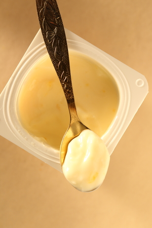 Yogurt pot with full spoonの写真素材