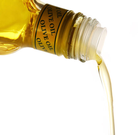 Pouring olive oil from bottleの写真素材