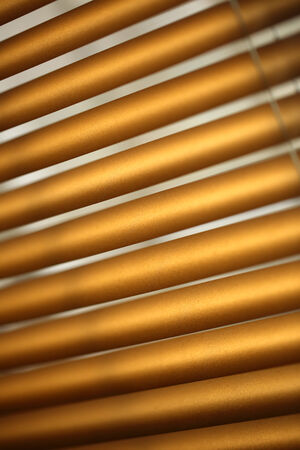 Daylight through brown metal jalousieの写真素材