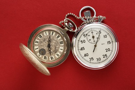 Pocket vintage watch and stopwatch on redの写真素材