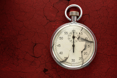Single stopwatch closeup on red cracked backgroundの写真素材