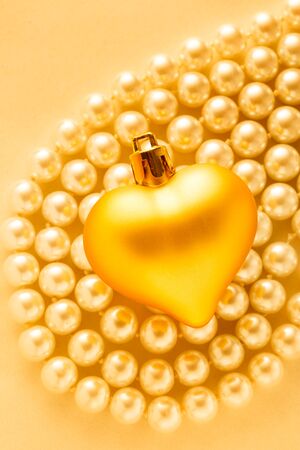 Heart on white pearl necklace in romantic lightの写真素材