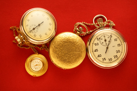 Pocket vintage watch and stopwatch on redの写真素材