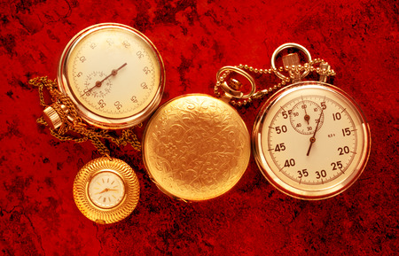 Pocket vintage watch and stopwatch on red