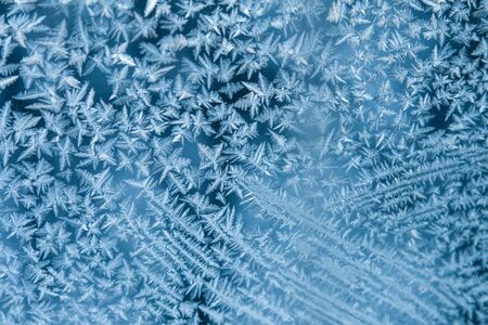 Shiny winter window ice snowflakes decoration closeup