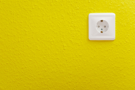 Single electric socket with plug on wallの写真素材