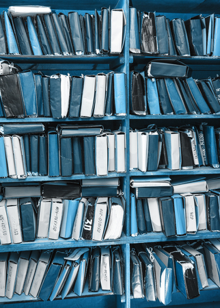 Paper documents stacked in archive on shelfの写真素材