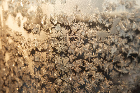 Shiny winter window ice snowflakes decoration closeup