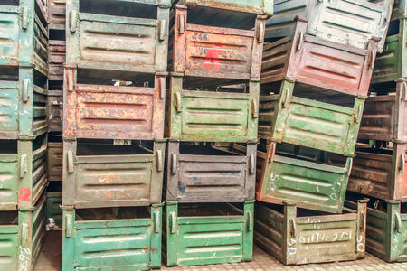 Old metal boxes stacked in storehouse of factoryの写真素材