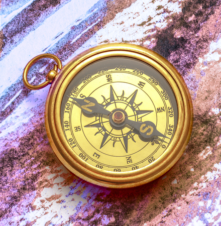 Vintage compass on abstract watercolor painting backgroundの写真素材
