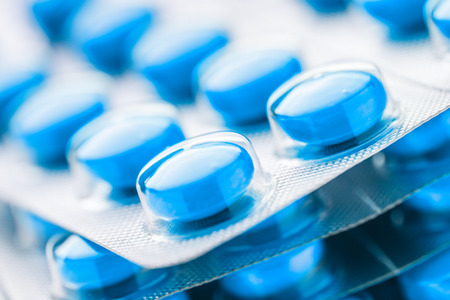 Colourful tablets in plastic packing as backgroundの写真素材