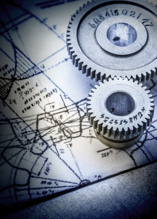 Steel cogwheels connected on drawing in toningの写真素材