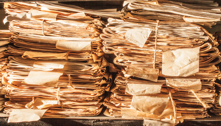 Paper documents stacked in archive in closeup