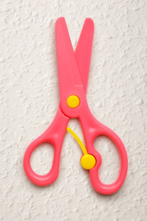 Pink safe children scissors on white backgroundの写真素材