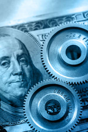 Mechanical ratchets and dollar in toning closeupの写真素材