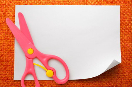 Safe scissors on blank white piece of paperの写真素材