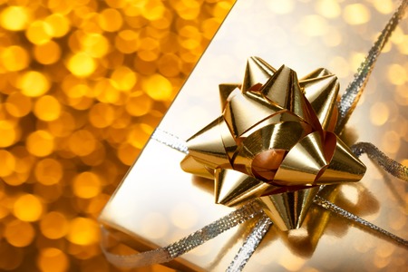 Decorated gift box with bow on blur backgroundの写真素材