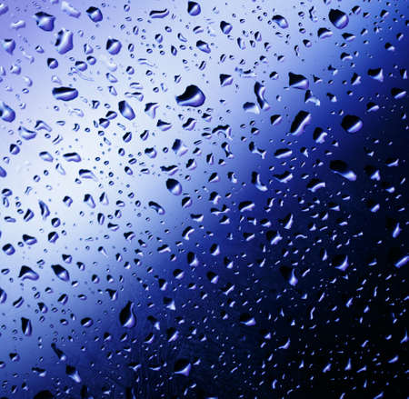 Cold rain drops on window as backgroundの写真素材