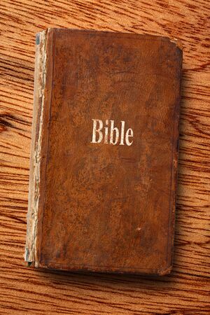 Old Bible book on the wooden backgroundの写真素材
