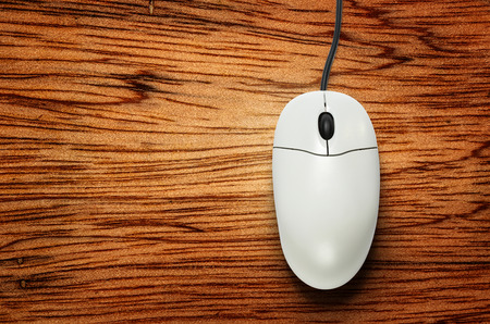 Computer mouse on wooden background  in closeupの写真素材