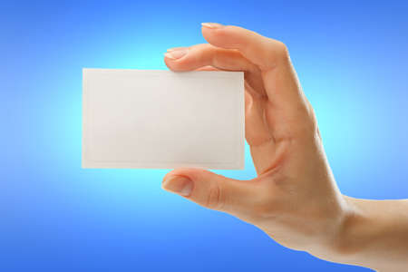 Blank card in female hand in closeupの写真素材