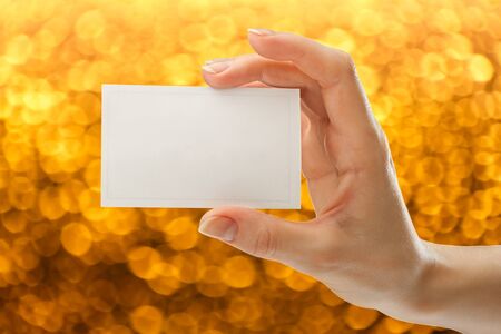 Blank card in female hand in closeupの写真素材