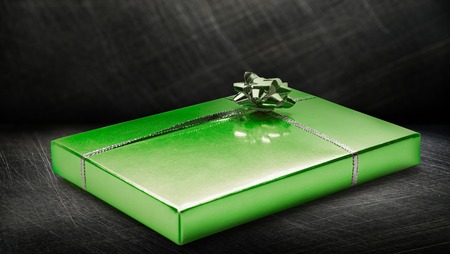 Gift box with bow on steel backgroundの写真素材