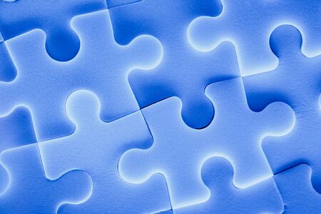 Jigsaw puzzle pieces as background in closeupの写真素材
