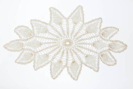 Crocheted lace napkin as home decoration on white