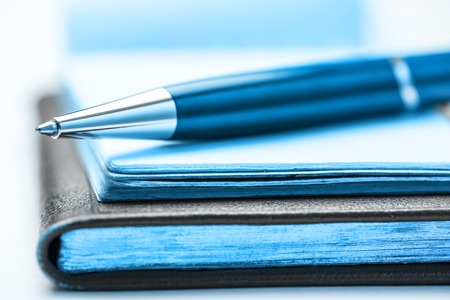 Paper blocks with pen on it in closeup