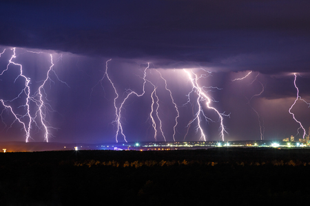 Night thunder lightning over the city sky viewの写真素材
