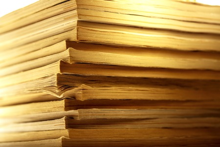 Stack of old magazines as background in toning