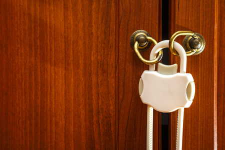 Safety plastic lock for kid protection on wardrobeの写真素材