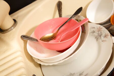 Dirty dishes in kitchen sink in closeupの写真素材
