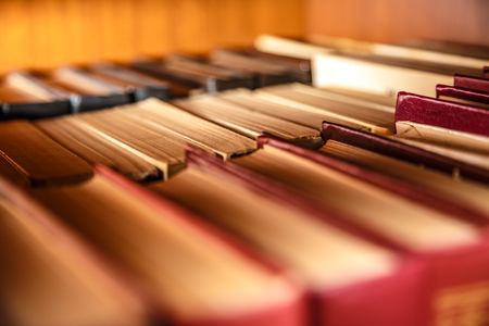 Old books on shelf in the Libraryの写真素材