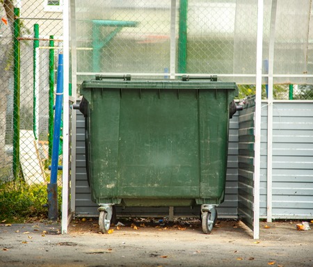 Photo of single green garbage bin outsideの写真素材