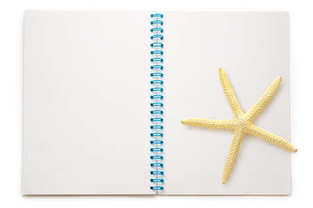Blank open notepad with sea star on white background