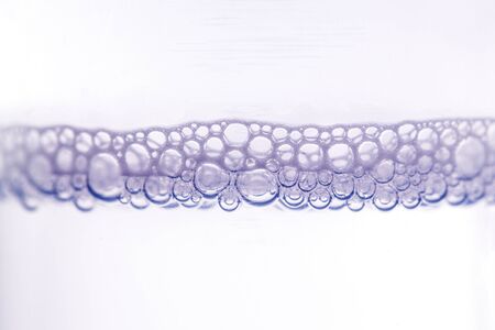 Shampoo bubbles in closeup as background