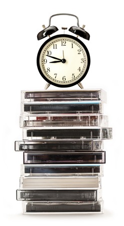 Stack of old cassettes and alarm clock