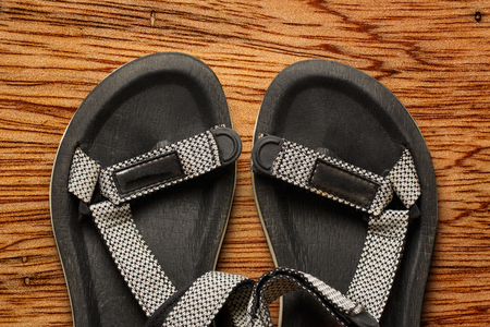 Male beach sandals on wooden background closeupの写真素材