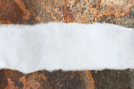 Ragged piece of paper on rusty backgroundの写真素材