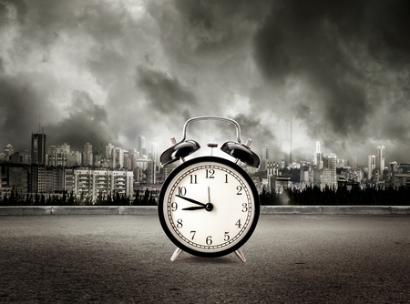 Clock on view of city in stormy sky background