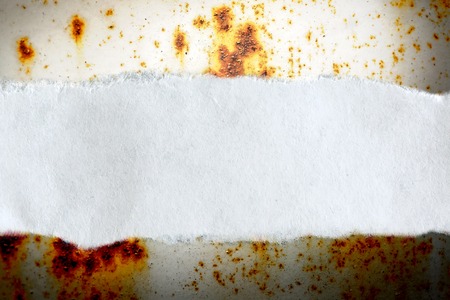 Ragged piece of paper on rusty backgroundの写真素材