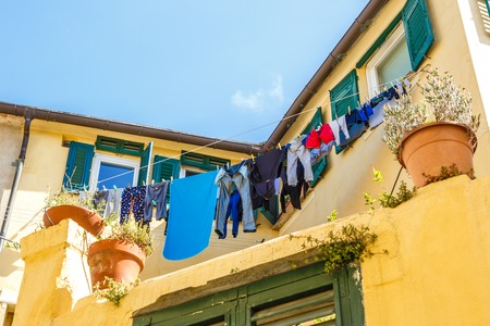 Clothes hanging out italian windows in lineの写真素材