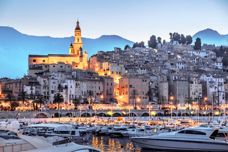 Riviera town Menton view with mountain and church in sunsetの写真素材