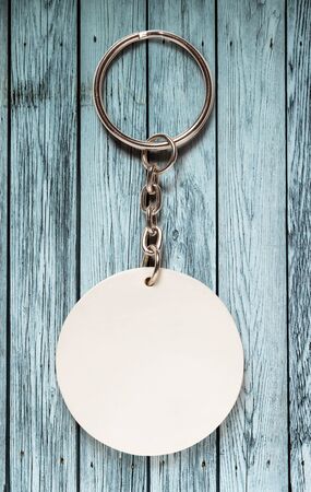 Key ring with round trinket on wooden backgroundの写真素材