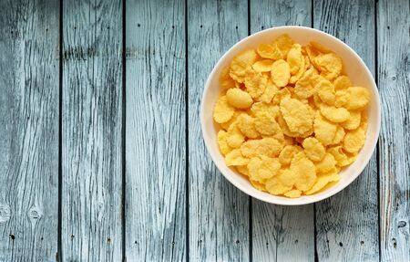 Yellow corn flakes in the white bowlの写真素材